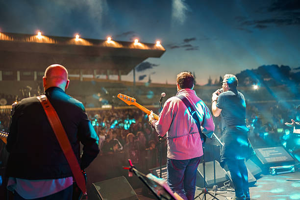 istock Rock Band Performing Live on Stage with Vibrant Lighting 2227229507