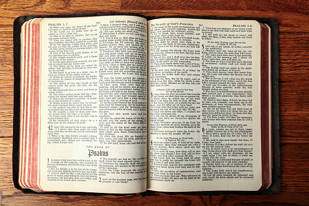 Vintage Bible open to the Book of Psalms on a wood table