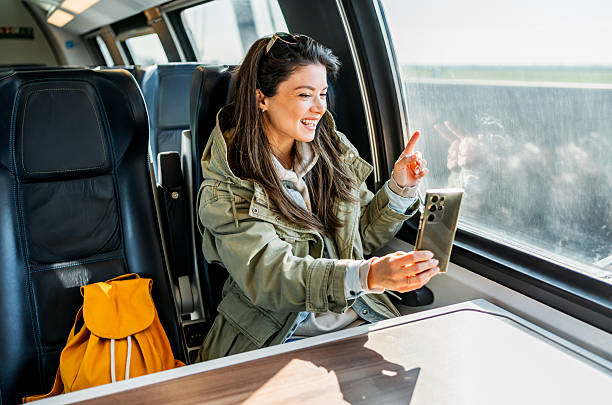 istock Young woman making a video call while traveling by train 2227230749