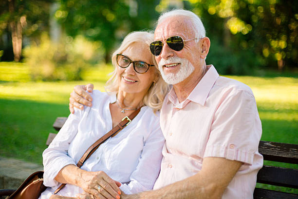 istock Happy senior couple relaxing on park bench 2227230925