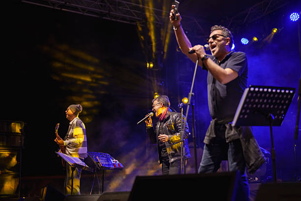 istock Rock Band Vocal Singing Live on Stage with Vibrant Lighting 2227230975