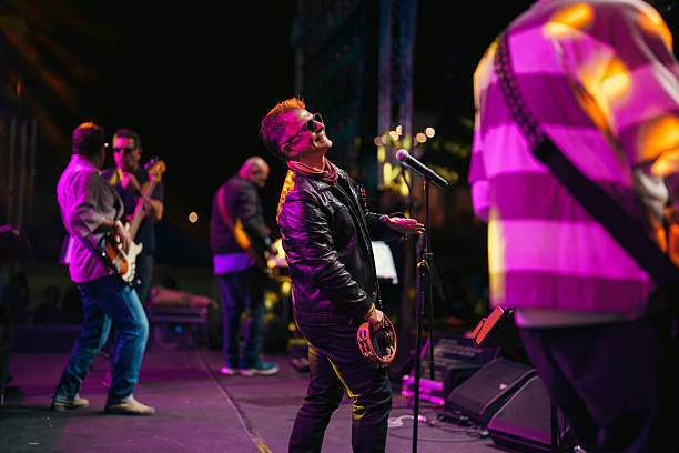 istock Rock Band Vocal Singing Live on Stage with Vibrant Lighting 2227231229
