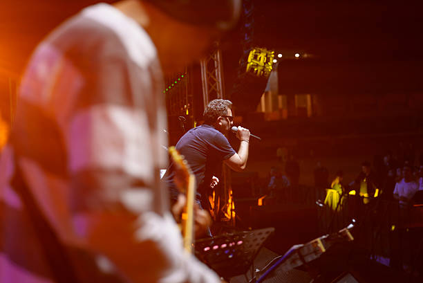 istock Rock Band Vocal Singing Live on Stage with Vibrant Lighting 2227231234