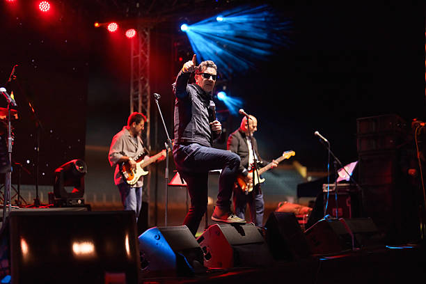 istock Rock Band Vocal Singing Live on Stage with Vibrant Lighting 2227231743