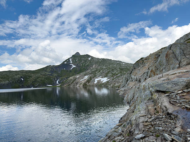 Nestled high in the heart of the Swiss Alps, this alpine lake is a breathtaking example of nature’s raw beauty and serenity. Surrounded by towering snow-capped peaks, lush green meadows, and whispering pine forests, the lake shimmers with crystal-clear turquoise waters fed by ancient glaciers.