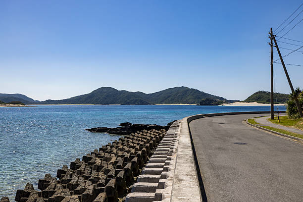coastal road and wave breaker on aka island, kerama islands, okinawa islands, japan.