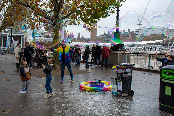 The River Thames creates a backdrop for a long ribbon of a bubble created by Bubbles Man (Michael Hopkins).