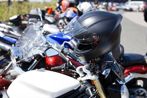 Close-up of a Vemar motorcycle helmet placed on a parked bike handlebar during the Distinguished Gentleman's Ride in Reggio Calabria.