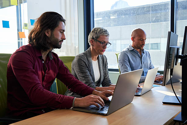 istock Three multiracial business colleagues sitting in the office working using laptops. 2227241645