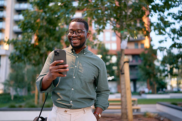 istock Smiling Businessman Checking Phone Outdoors 2227242478