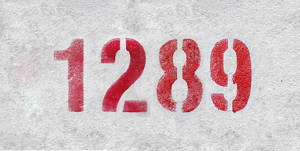 istock red spray-painted number 1289 sprayed onto a white wall. 2227246111