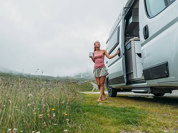 istock Woman Enjoying Coffee by Campervan in Mountains 2227247625