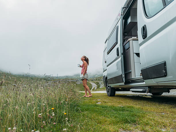 istock Woman Enjoying Coffee by Campervan in Mountains 2227247631