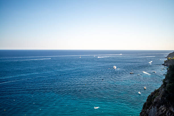 A breathtaking view of the Amalfi Coast showcasing dramatic cliffs, crystal-clear blue waters, and charming coastal architecture.