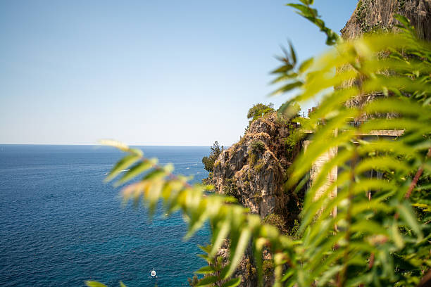 A breathtaking view of the Amalfi Coast showcasing dramatic cliffs, crystal-clear blue waters, and charming coastal architecture.
