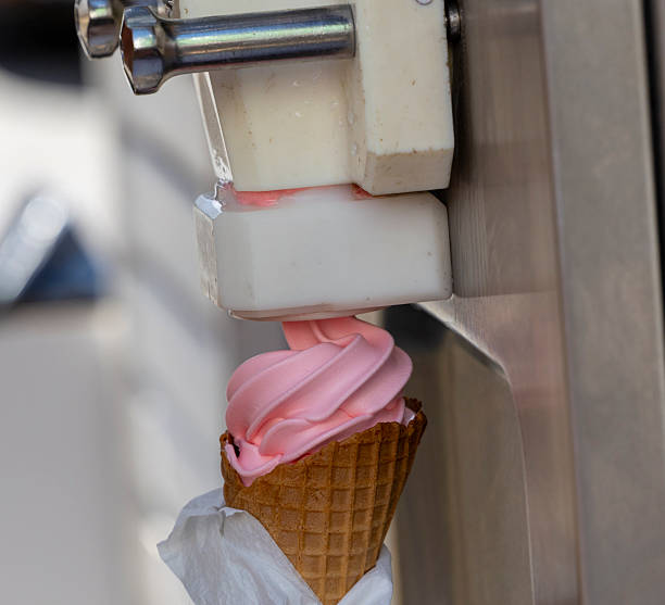 istock Soft serve ice cream being dispensed into a waffle cone 2227249361