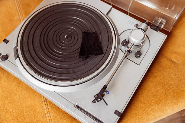 istock Cleaning a vintage turntable with microfiber cloth for retro music enjoyment 2227250184
