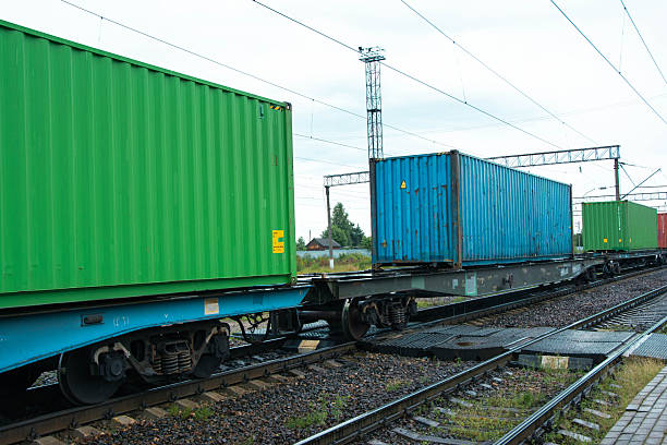 istock Freight train carrying colorful cargo containers on railway tracks 2227250642