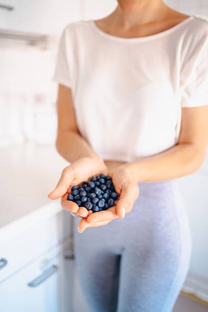 istock Woman holding blueberries 2227253943