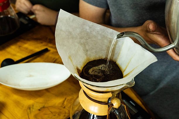 istock Unrecognizable barista pouring hot water into coffee dripper 2227255499
