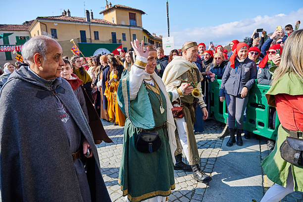 Ivrea, Italy - March 02, 2025: a woman with traditional costume riding an horse during the historical parade at Ivrea Carnival.