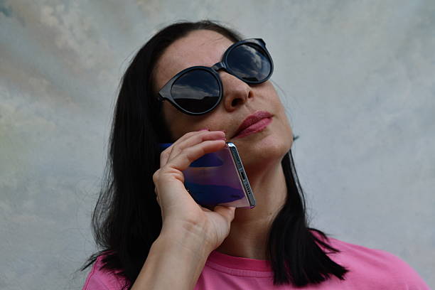 Portrait of a girl photo model holding a smartphone in her hands
