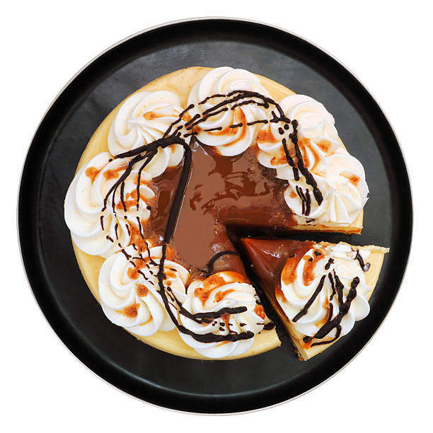 istock Caramel cheesecake on a black plate isolated on white 2227259880