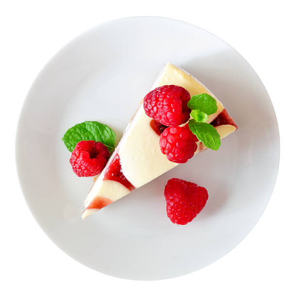 Slice of raspberry cheesecake on a plate isolated on white