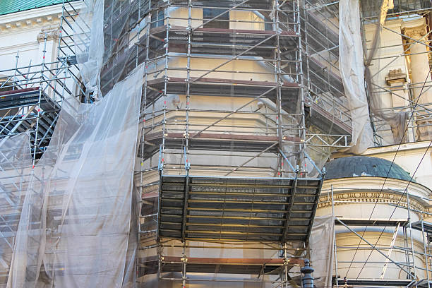 istock Historic building facade with ornate architectural details partially covered by transparent protective material during restoration 2227260164