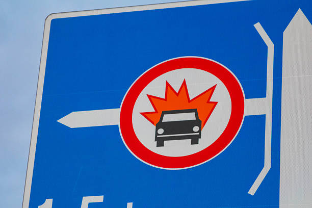 Blue circular traffic prohibition sign featuring red maple leaf symbol with white prohibition bar crossing through design