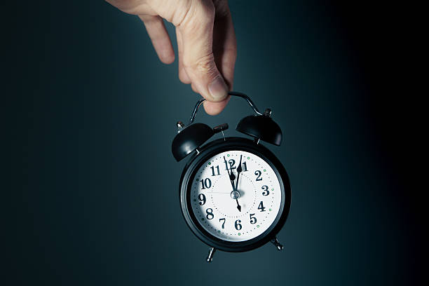 istock hand holds a black watch. 2227262769