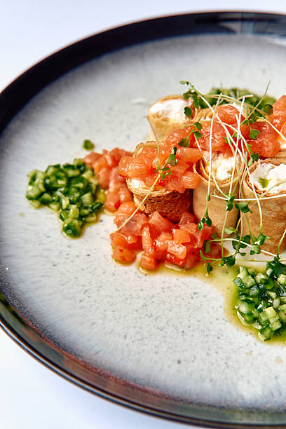 istock A Delicately Plated Dish Featuring Rolled Tortilla Filled with Creamy Ingredients, Accompanied by Fresh Diced Tomatoes and Green Garnishes on a Modern Plate 2227266791