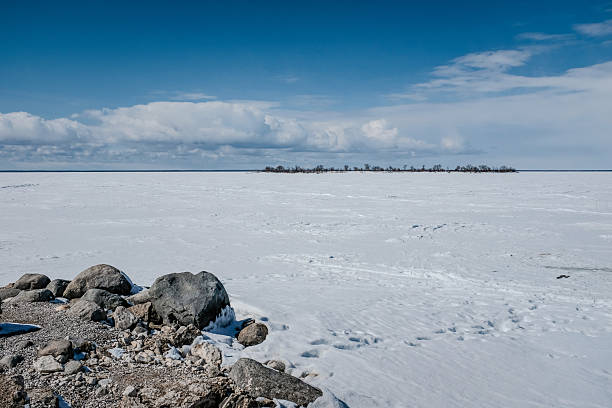 An island surrounded by a frozen lake in northern Manitoba