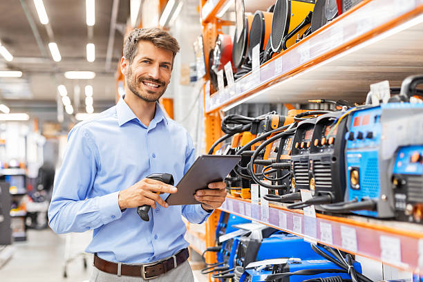 istock Portrait of happy man using digital tablet in hardware store 2227273297