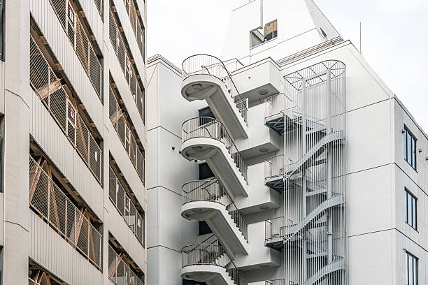 White and blue emergency stairs winding around a modern building, creating a striking visual contrast