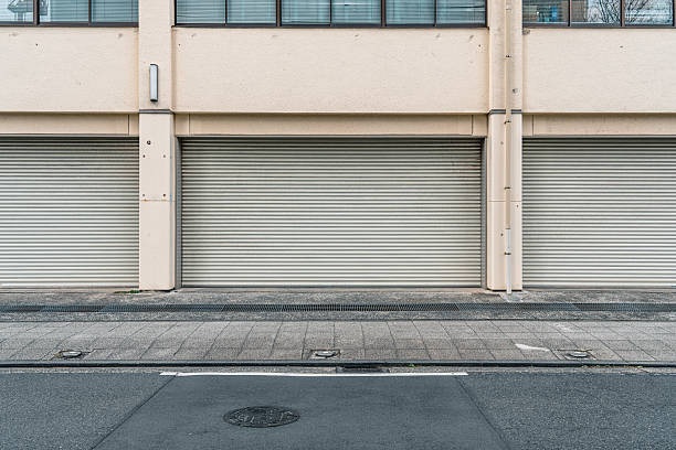 istock Closed roller shutters on a building facade in an urban setting 2227277003
