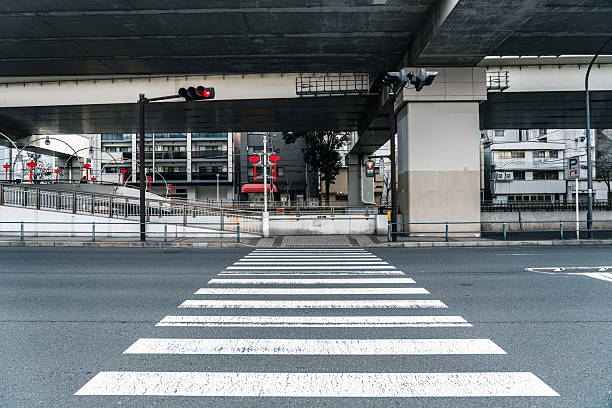 Empty crosswalk under elevated highway in urban japan