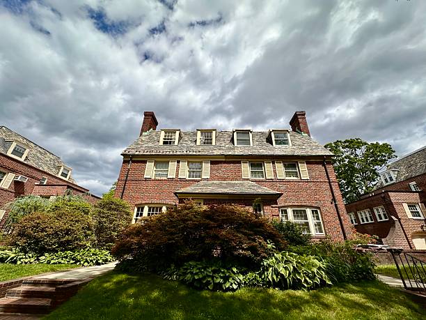 Side View of The Home of Franklin D. Roosevelt, 32nd President of the United States, is a National Historic Site. This site preserves the Springwood estate which is located in Hyde Park, New York. The Springwood was the birthplace, home, and burial place of the FDR (Franklin Delano Roosevelt). Blue Sky with clouds, grass and trees in fall colors are in the image. HDR (high dynamic range) image, Canon EOS 6D (full frame sensor) DSLR and Canon EF 24-105mm F/4L IS lens.