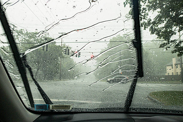 istock Wipers Splashing Drenching Downpour Summer Rain Storm Water Across Car Windshield 2227280212