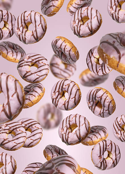 istock Levitating donuts with pink icing on a bright pink background 2227280231