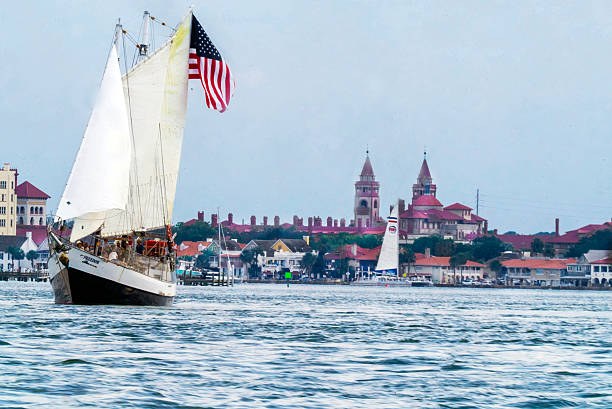 A Freedom Schooner cruise on Matanzas River, a part of the Intracoastal Waterway, cruises past  a section of St. Augustine, Florida's waterfront. Towers from Flagler College loom large in the background.