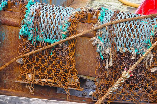 Vibrant close-up showing rusted chains and knotted ropes against a weathered metal surface—ideal for maritime editorial, texture-rich design, or industrial-themed stock assets