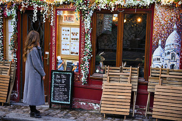 A woman passing by a decorated restaurant in Montmartre, Paris, France. Photo taken on February 22, 2025.