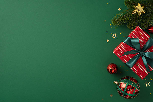 Green holiday-themed background featuring a decorative gift box, ornaments, and festive elements symbolizing Christmas celebration