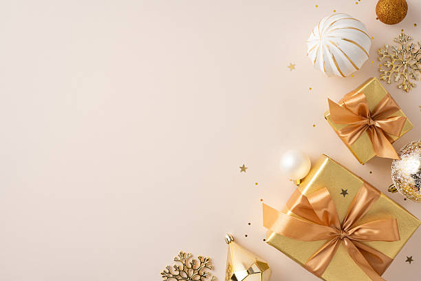 istock Golden gift boxes with bows and festive ornaments displayed elegantly with soft golden tones 2227284150