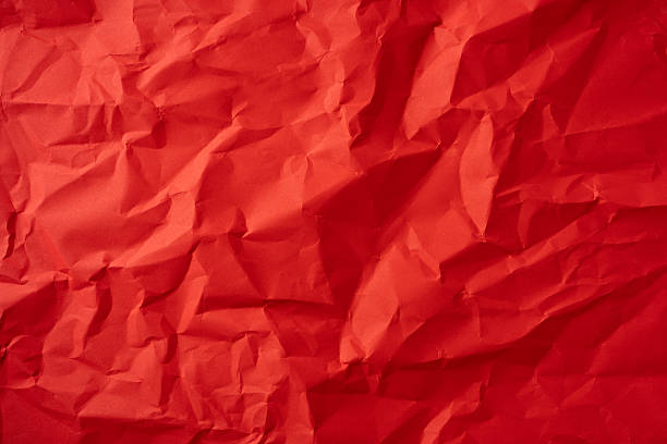 Bright red crumpled paper texture suitable for modern designs, presentations, or artistic works
