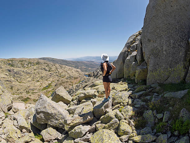 Athlete in the mountains observing the landscape