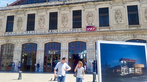 July 26, 2017. Marseille. France. A sunny day at the historic Gare de Marseille Saint-Charles train station, featuring its ornate facade and people going about their day.