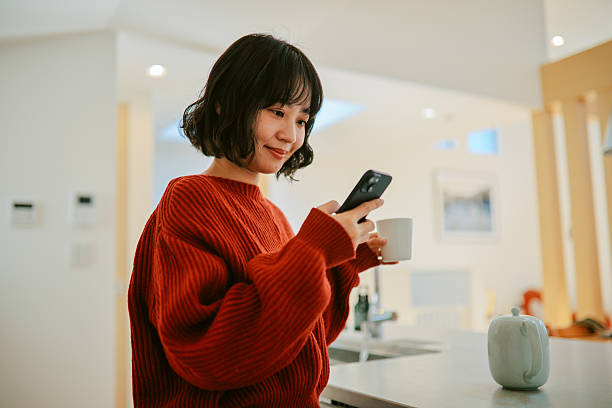 istock Woman reads an article on her smartphone while relaxing at home 2227288330