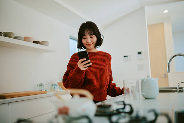 istock Woman reads an article on her smartphone while relaxing at home 2227288594